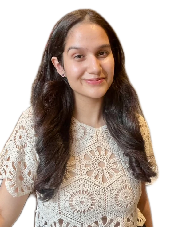 Tushti, smiling, in a cream crochet top